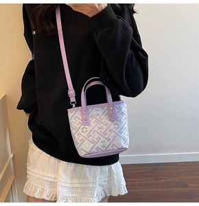 Close-up of purple geometric jacquard pattern and leather trim on a mini bucket bag