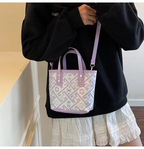Detail of purple patent leather bucket bag with geometric patterns and crossbody strap