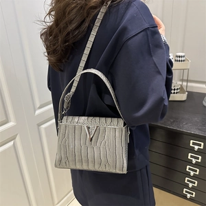 Elegant grey crocodile embossed handbag with silver V-clasp and adjustable strap