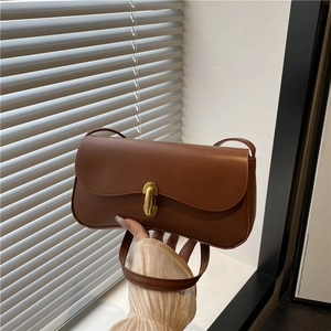 Chic brown leather shoulder bag with gold metal buckle and vintage minimalist design