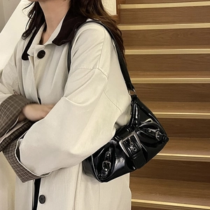 Glossy black patent leather underarm bag with decorative metal buckles for Y2K style