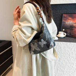 Chic black underarm bag with silver butterfly embroidery and wooden bead strap