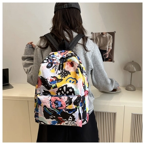 Detail of trendy backpack with colorful abstract print and front zipper pocket