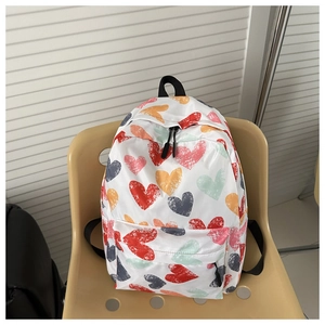 Close-up of lightweight backpack with colorful heart graffiti pattern and front pocket