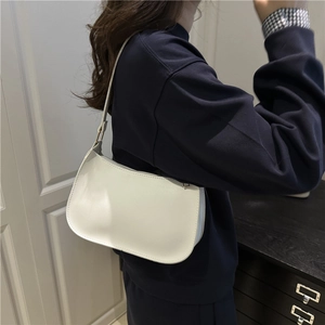 Minimalist white crescent underarm bag in premium PU leather shown on a model