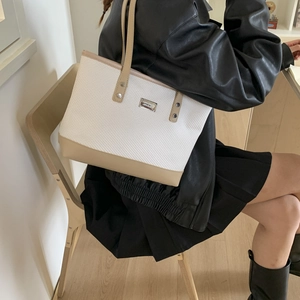 Minimalist bicolor tote bag with woven texture and khaki leather straps for women