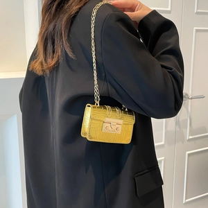 Fashionable gold crocodile pattern crossbody bag with chain strap and sleek metal clasp