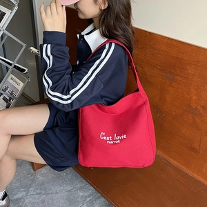 Minimalist red canvas shoulder bag with white graphic text for women daily commute