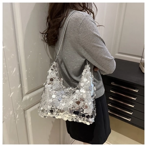 Detailed view of silver sequin hobo bag showing metallic texture and round paillettes