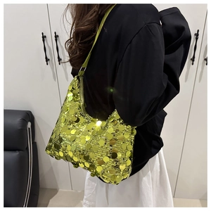 Detail of sequined dumpling bag in neon yellow showing metallic luster and fabric strap