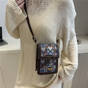 Chic geometric woven crossbody phone bag with brown leather trim and golden pendant