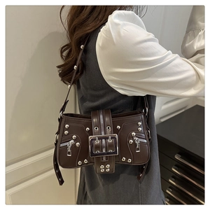 Detail of dark brown vintage Y2K shoulder bag with silver studs and metal buckle strap