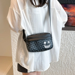 Minimalist crossbody bag with geometric triangle patterns and graffiti smiley face design