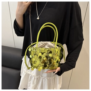 Detail of neon green sequin bucket bag with drawstring liner and metallic chain strap