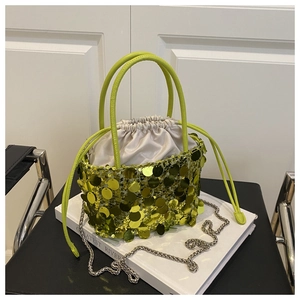 Detail of lime green sequin bucket bag with drawstring inner pouch and silver chain