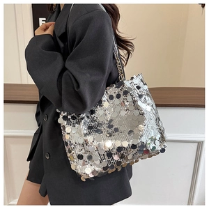 Détail d'un sac à bandoulière à paillettes argentées avec chaîne et design bucket