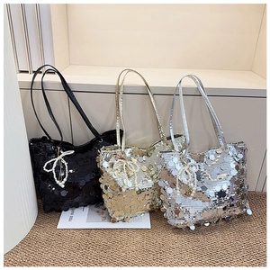 Detailed view of sequin tote bags in black, gold and silver with pearl bow charms
