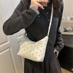 Minimalist white bucket bag with silver studs and polished synthetic leather finish