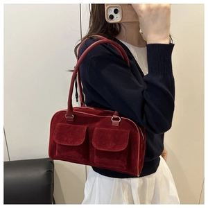 Mirror selfie showing a vintage dark red suede shoulder bag with dual front pockets