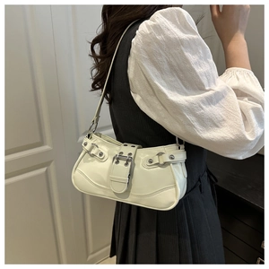 Detail of off-white faux leather underarm bag with silver square buckle and metal rivets