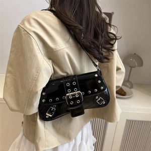 Black patent leather shoulder bag with punk silver studs and buckle in trendy biker style