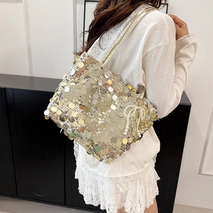 Chic gold sequin tote bag for women with a decorative pearl bow charm on the strap
