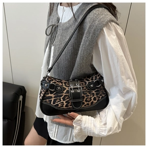 Detail of leopard print underarm bag with silver grommets and black leather trim