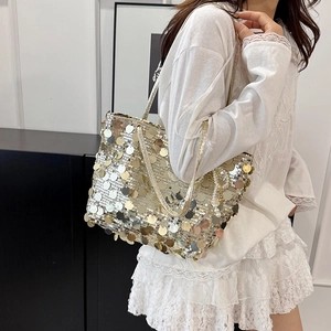 Chic gold sequin tote bag shown on a model with minimalist modern interior backdrop