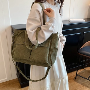 Olive green corduroy tote bag with large front pockets and adjustable shoulder strap