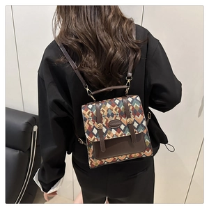 Detailed view of women's woven backpack featuring vintage colorful patterns and leather trim