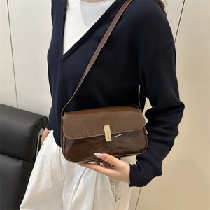 Brown patent leather shoulder bag with sleek rectangular metal buckle for women