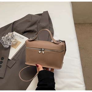 Close-up of litchi texture mini crossbody bag with heart-shaped metal zippers