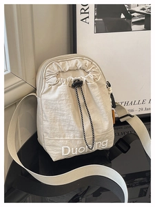 Detail of off-white nylon drawstring bucket bag with embroidered logo and wide strap