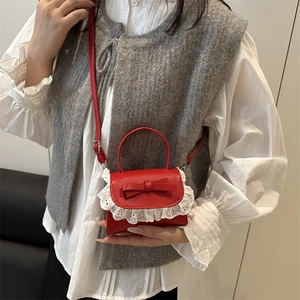 Red leather mini crossbody bag with white lace trim and bow detail for women