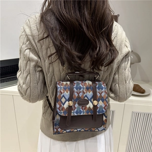 Vintage woven plaid backpack with brown leather trim and golden metal accents