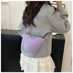 Detailed knit texture and pearl closure of the lavender handmade crochet bucket bag