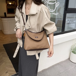 Women's autumn canvas and leather crossbody dumpling bag with bead tassel detail