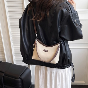 Minimalist cream canvas and brown leather crossbody dumpling bag for autumn style