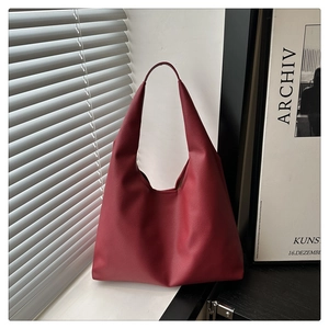 Macro detail of wine red tote bag with premium lychee grain texture for women
