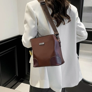 Brown vintage faux leather bucket bag with wide strap and metallic logo for women