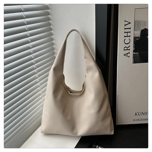 Detailed view of the creamy beige hobo bag with high-quality lychee grain leather texture