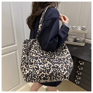 Detailed close-up of a leopard print tote bag with a front pocket for daily use