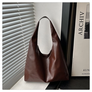 Detail view of large dark brown matte PU leather tote bag with wide shoulder strap