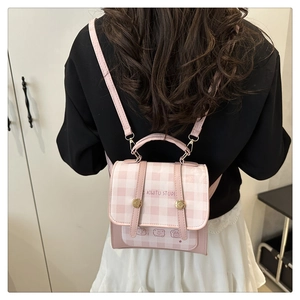 Rear view of a pink plaid mini backpack with cartoon graphics and adjustable PU straps