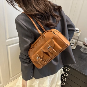 Retro caramel patent leather underarm bag with buckle pockets on model back
