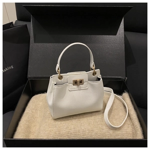Detailed shot of white litchi grain leather bucket bag in premium gift box packaging