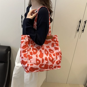 Stylish 2025 pink leopard print tote bag with large front pocket and rivet details