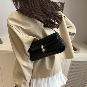 Chic black baguette underarm bag with crocodile texture and golden metal buckle