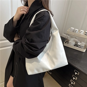 Minimalist white PU leather crescent tote bag with large capacity shown on model