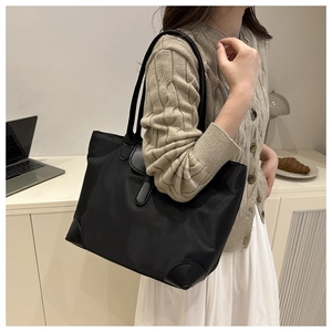 Detail of minimalist black tote bag with reinforced PU corners for daily commuting